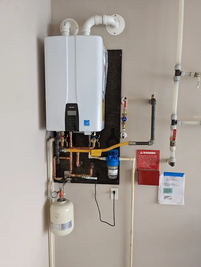 Professional plumber installing copper piping in a Lake Park home